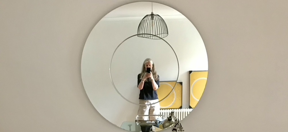 Me photographing myself in a big round mirror