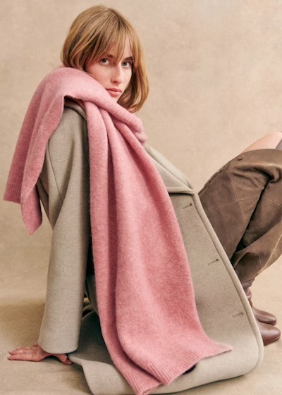 Soft pink blanket scarf over beige coat