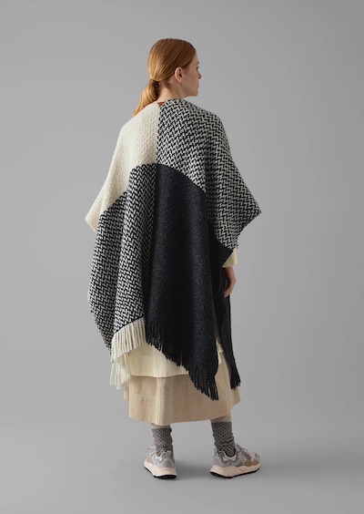 Black, grey and natural big wrap blanket scarf draped over shoulders