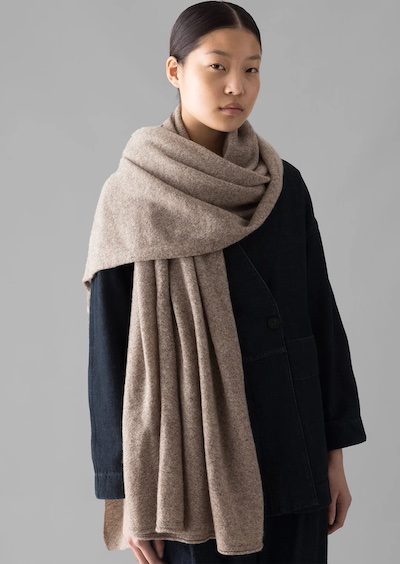 Beige blanket scarf worn as a wrap